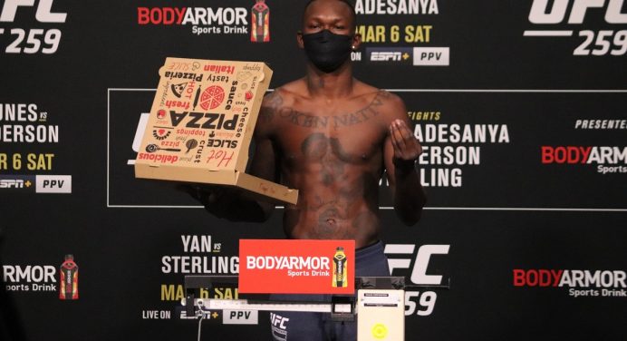 Israel Adesanya rouba a cena em pesagem do UFC com caixa de pizza na balança