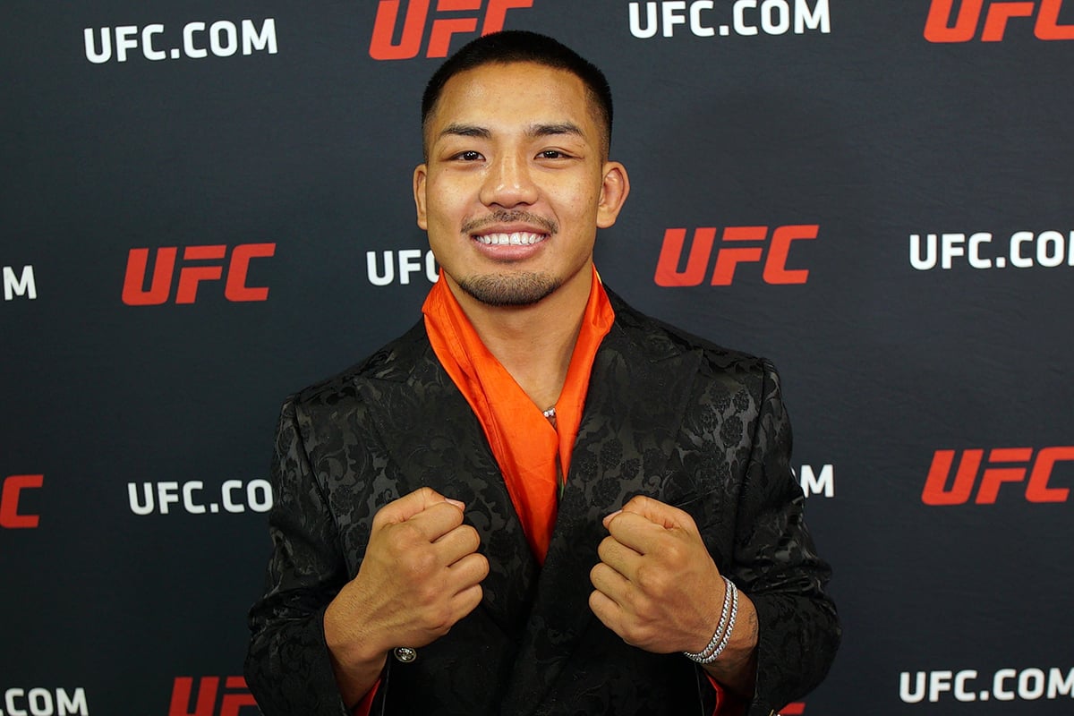 Sorridente, Joshua Van posa para foto após se tornar campeão no UFC 323