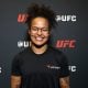 Aniversariante do dia, Karine Killer sorri para foto no media day do UFC 323
