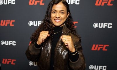De punhos cerrados e sorriso no rosto, Natália Silva posa para foto no media day do UFC 324